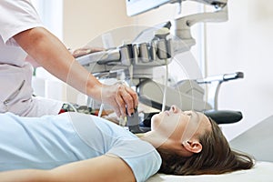 Woman patient during the ultrasound examination of a thyroid lying on the couch in medical office