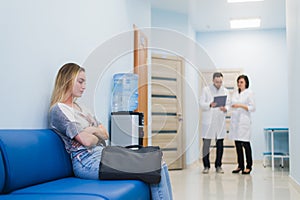 Woman patient waiting at hospital Doctors Waiting Room