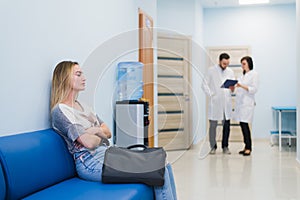 Woman patient waiting at hospital Doctors Waiting Room