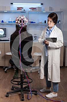 Woman patient wearing performant eeg headset scanning