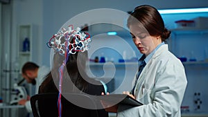 Woman patient wearing performant eeg headset scanning brain