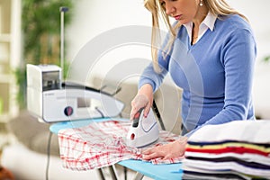 Woman patiently press clothes