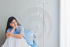 woman patients, is upset and sitting in patient`s bed with alone