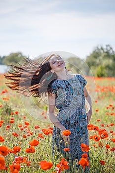 Woman in patterned sundress on sunset flower field