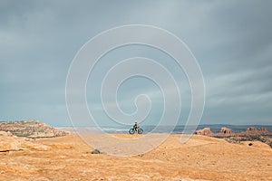 Woman pauses for a break during a strenuous fun mountain bike ride on Navajo Loop Trail in Utah