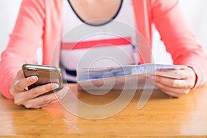 Woman pay bill online by smartphone.