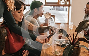 Woman paying the bill with her smartphone in a bistro