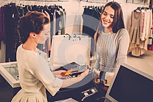 Woman paying with credit card in s showroom