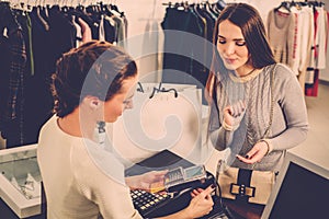 Woman paying with credit card in s showroom