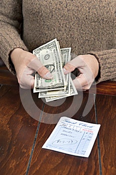 Woman paying dinner bill