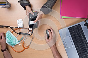 Woman paying the doctor with credit card flat lay