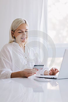 Woman paying with her credit card for online shopping