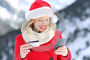 Woman paying on line with credit card in christmas