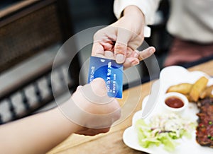 Woman paying lunch with credit card at restaurant