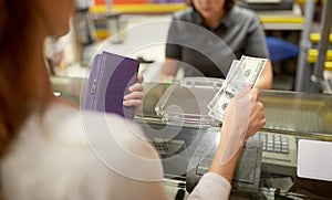 Woman paying money at store cash register