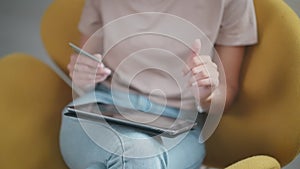 woman paying online on site of store, inputting data of credit card on screen of tablet, closeup view