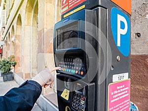 Woman paying for parking at the new Parking ticket payment machine