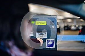 Woman paying ticket parking time space digital display