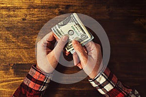 Woman paying with USA dollar money banknotes