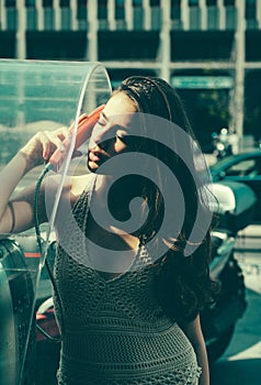 Woman with payphone. Communication. Oldstyled city. Old fashion town.