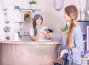 Woman pays with credit card in a shop