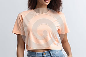 Woman in peach fuzz colored tshirt, can be used for design, mock up. The trending color of 2024.