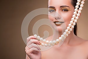 The woman with pearl necklace isolated on white