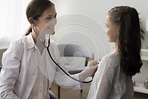 Woman pediatrician listen to little girl heart rate with stethoscope