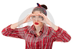 Woman peeking looking through fingers like binoculars