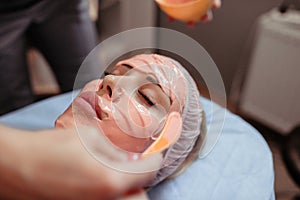 Woman with peel off face mask on her fase