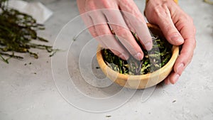 Woman is peeling and preparing wild asparagus to cook