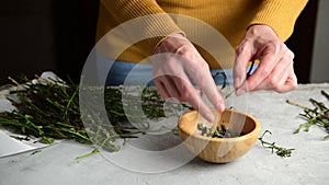 woman is peeling and preparing wild asparagus to cook