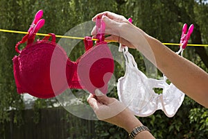 Woman pegging washing on clothes line