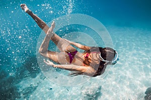 Woman with perfect body dive in the sea. Snorkeling with sexy lady in Hawaii