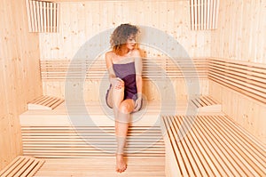 Woman with perfect skin taking body treatment in sauna