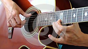 Woman performer hand play on guitar