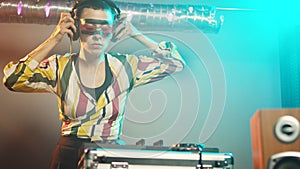 Woman performer mixing sounds at stereo turntables