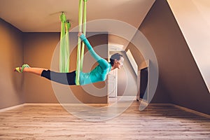 Woman performing antigravity yoga