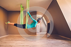 Woman performing antigravity yoga photo