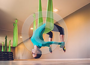 Woman performing antigravity yoga photo