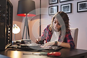 Woman performing computer maintenance