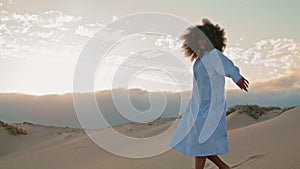 Woman performing contemporary style in sand desert summer evening. Girl dancing.