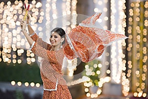 Woman performing Dandiya Raas on Navratri