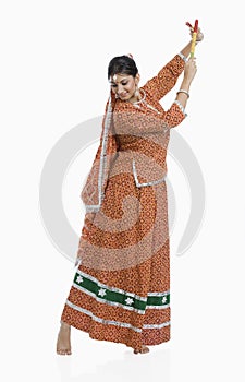 Woman performing Dandiya Raas on Navratri