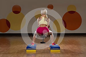 Woman Performing Dumbbell Barbell Squats