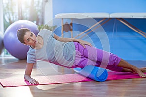 Woman performing exercise using foam roll
