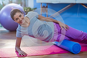 Woman performing exercise using foam roll