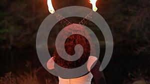 Woman performing fire spin with smoke