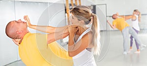 Woman performing palm heel strike while training in gym