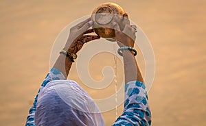 Woman performing rituals at the Ganges riverbank at Varanasi